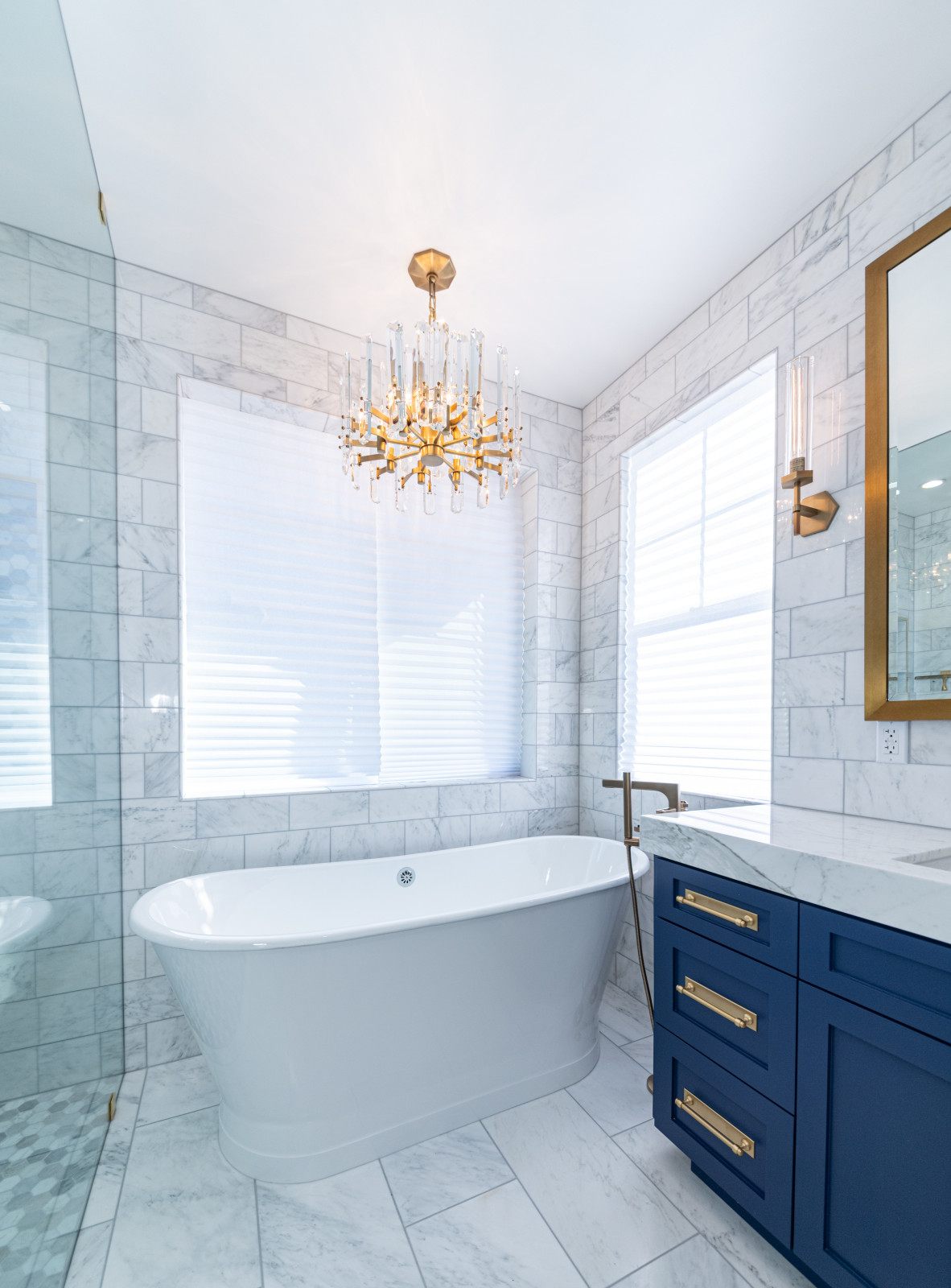 Master bathroom with freestanding tub and navy vanity