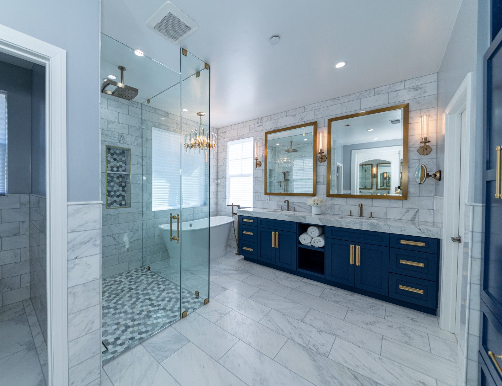 Westlake Village bathroom remodel — marble, navy vanity and gold mirrors