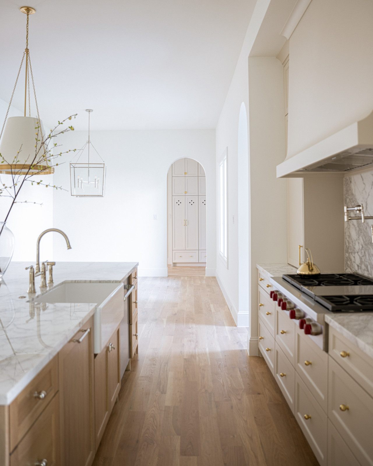Bright kitchen remodel with oak island, farmhouse sink and marble counters