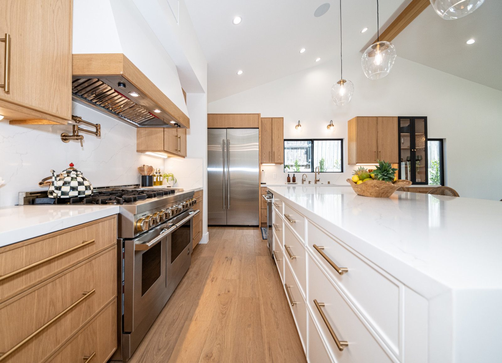 Kitchen remodel with white oak cabinetry, long island and professional range