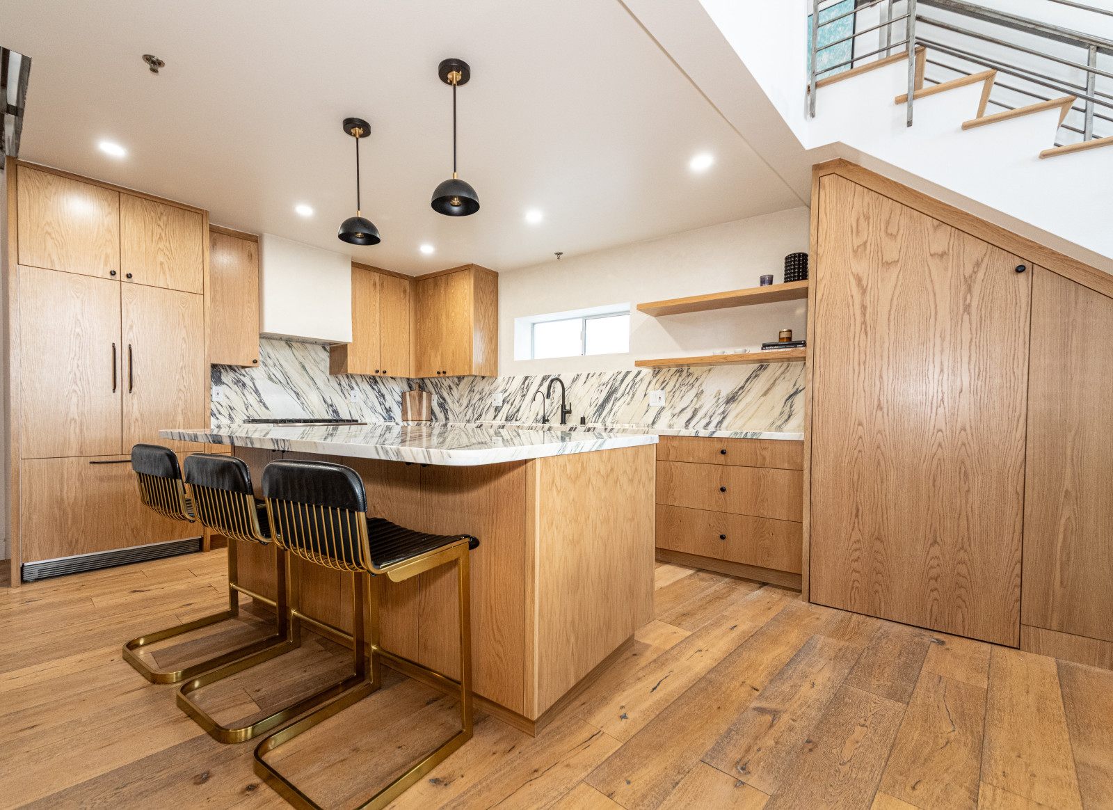Kitchen remodel with white oak cabinetry and marble backsplash