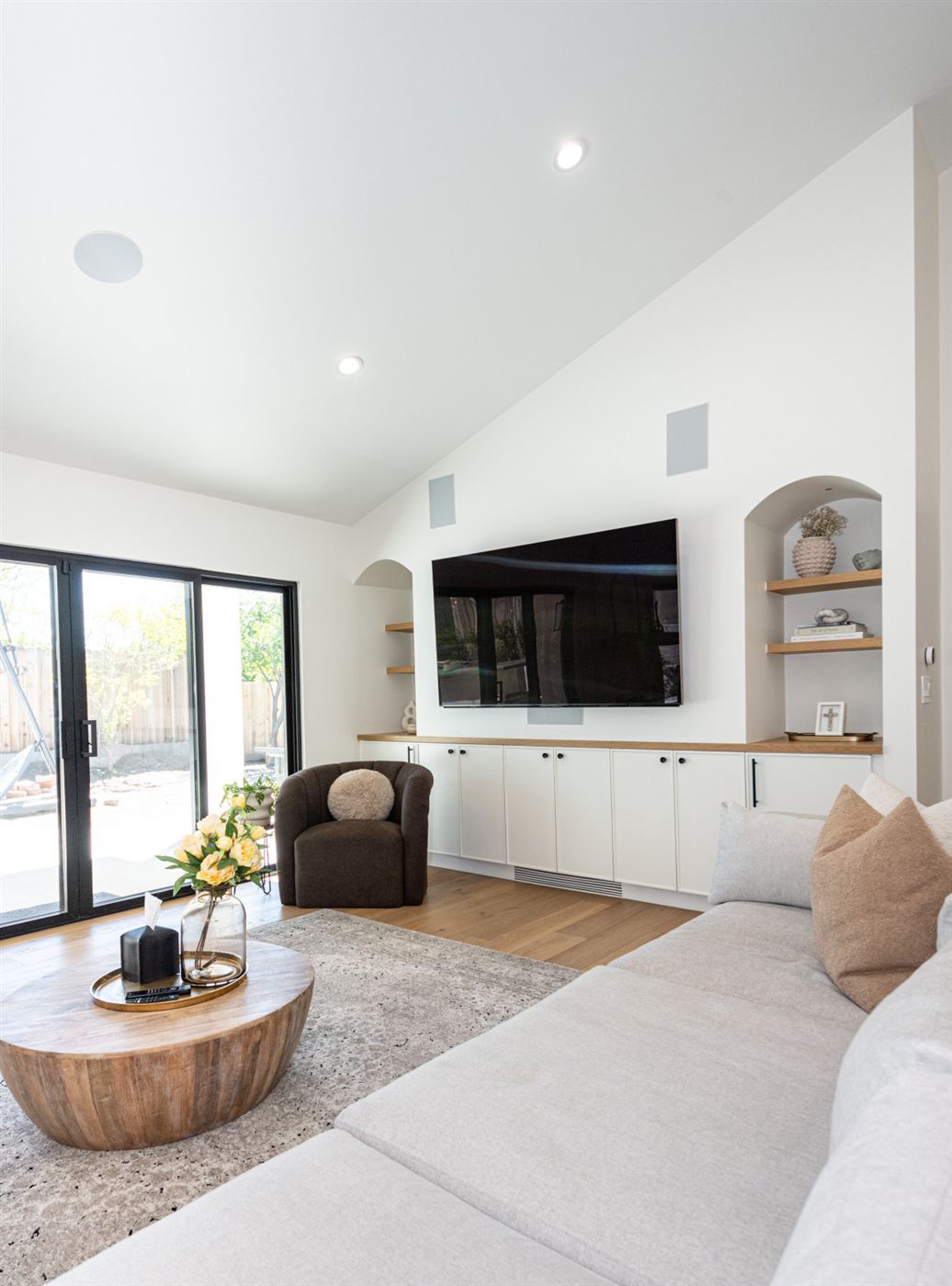 Living room with built-in white cabinetry and warm wood accents