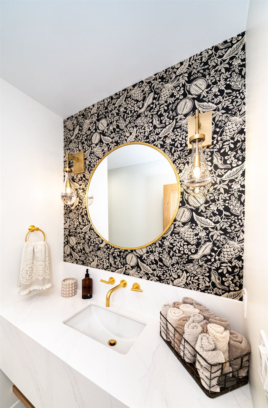 Bathroom vanity with botanical wallpaper and quartz counter