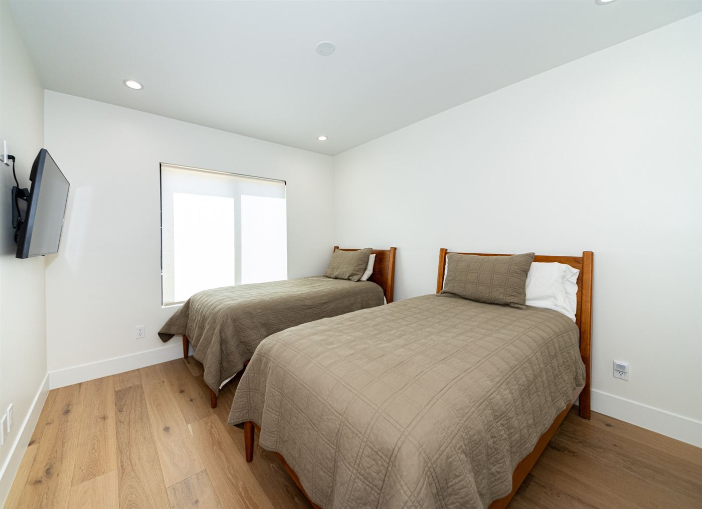 Guest bedroom with twin wood-frame beds