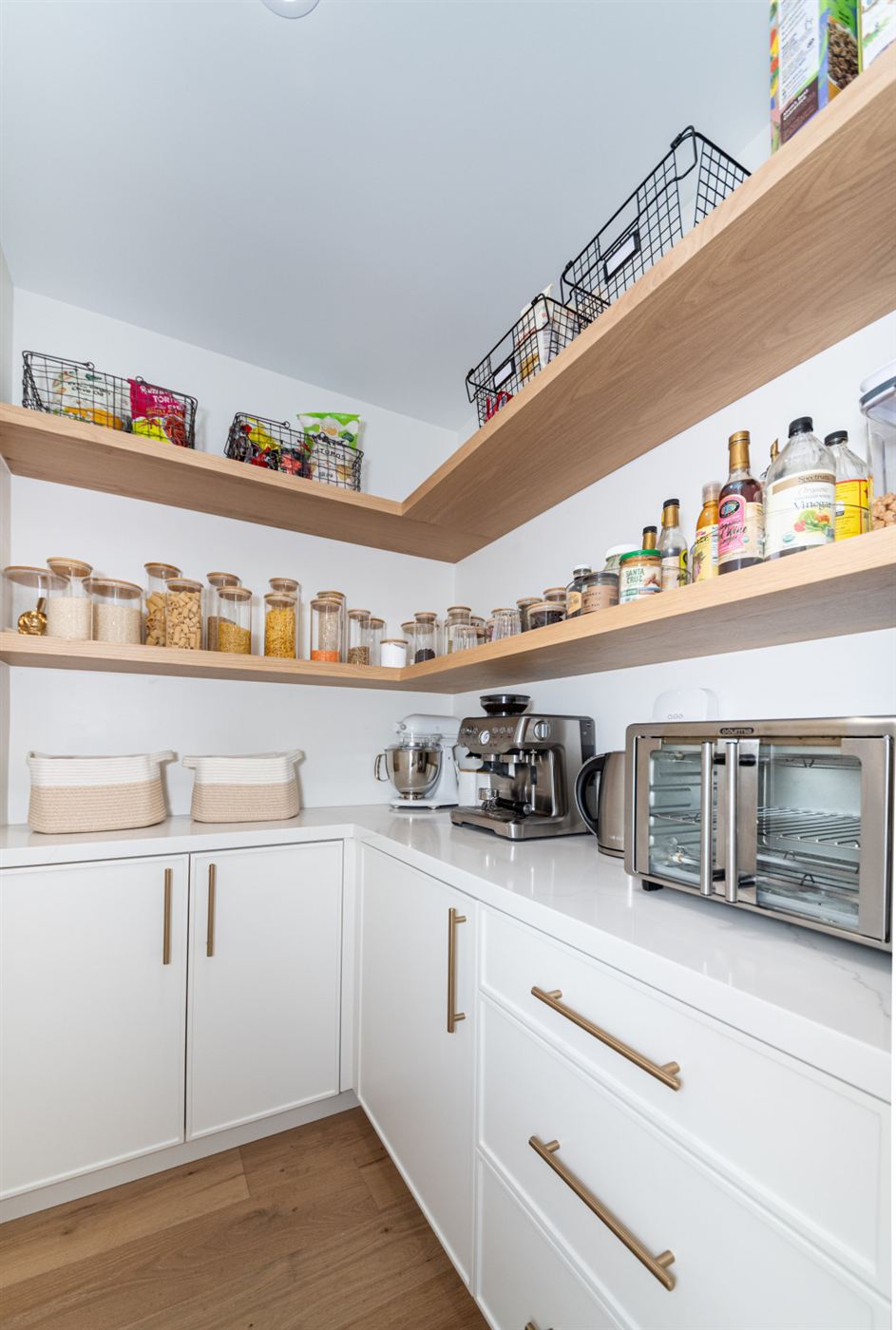 Organized pantry with open wooden shelves