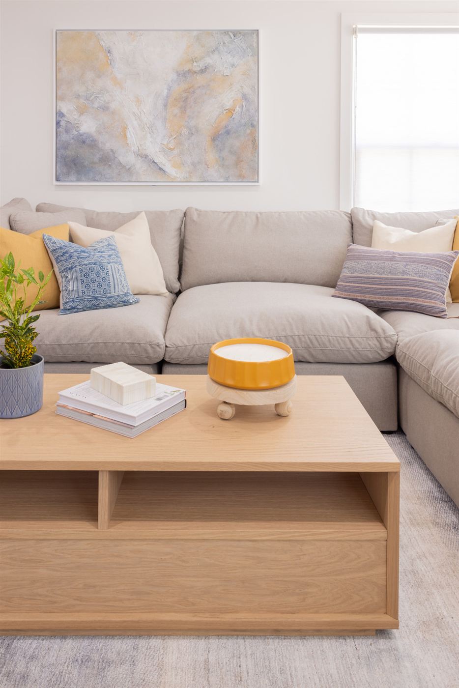 Living room with grey sectional sofa in neutral tones
