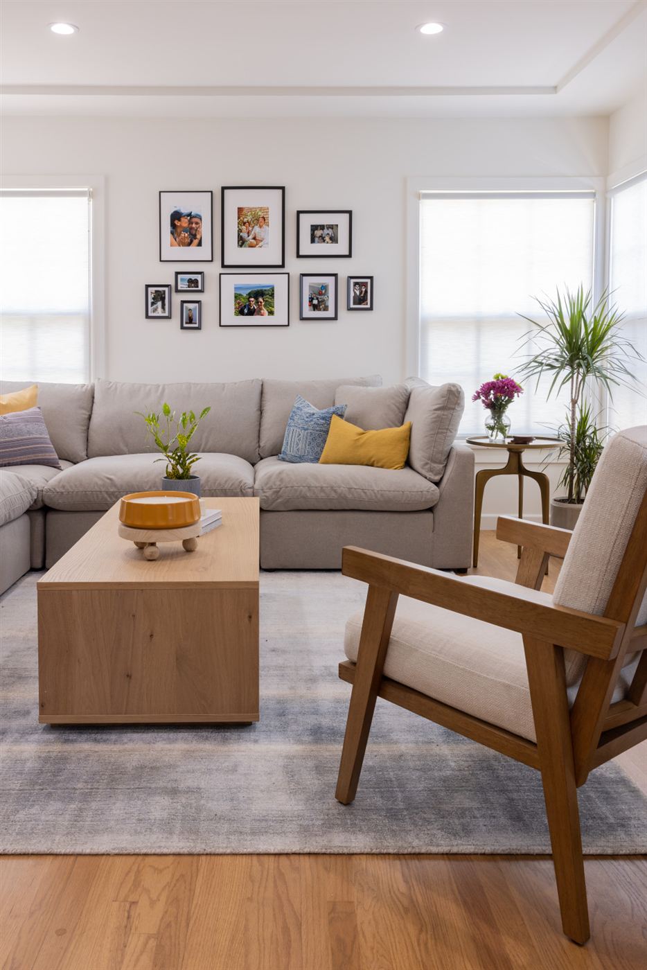 Well-lit living room with neutral palette and patterned rug