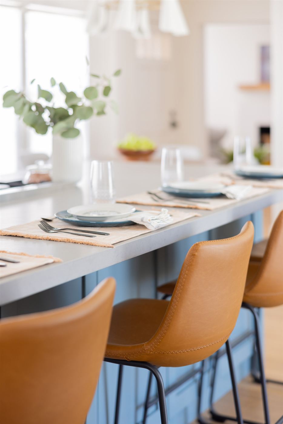 Kitchen island with grey countertop and soft blue cabinets