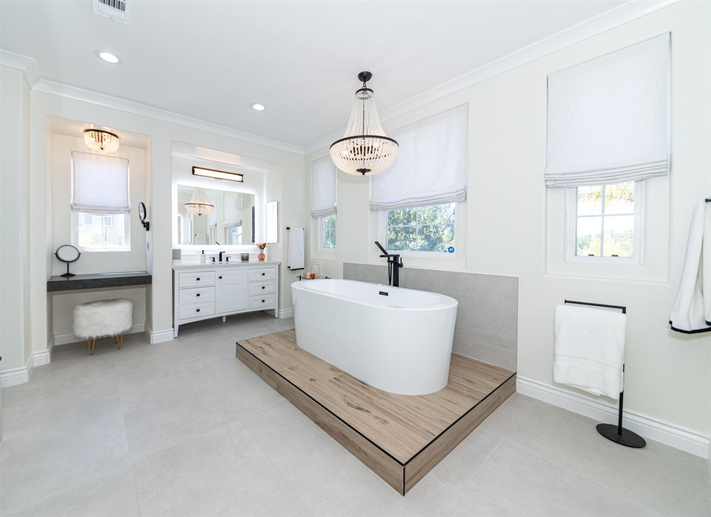 Westlake Village bathroom remodel â€” freestanding tub on wood platform with matte black fixtures