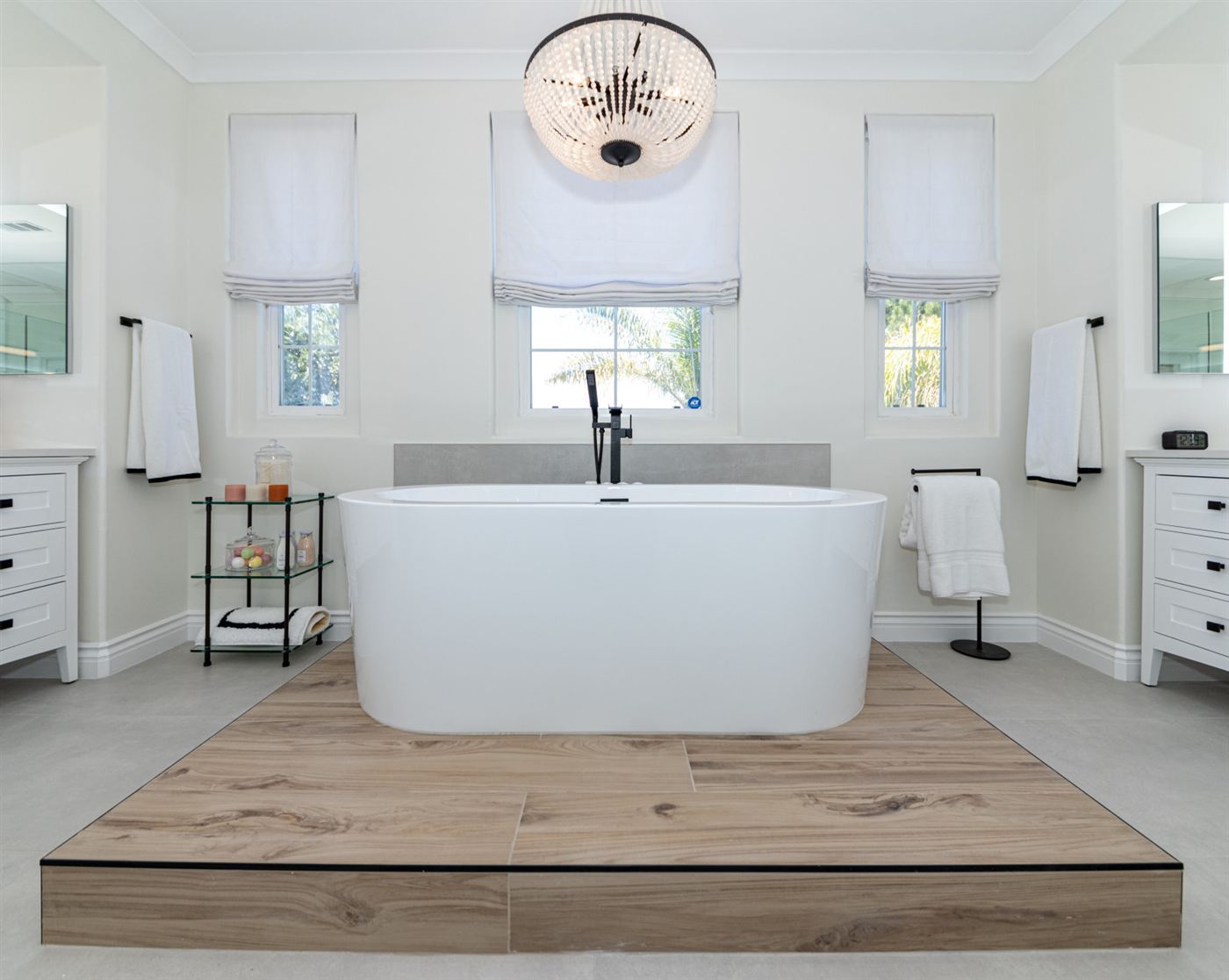 Westlake Village bathroom remodel â€” freestanding tub on wood platform with matte black fixtures