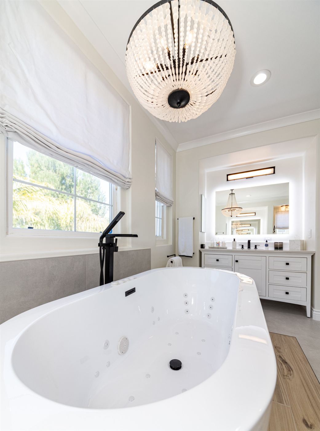 Westlake Village bathroom remodel â€” freestanding tub on wood platform with matte black fixtures